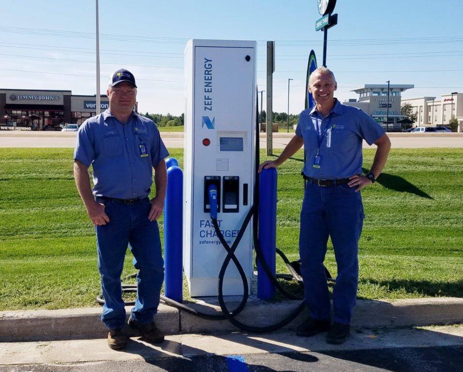Gray Electric team members by EV Station